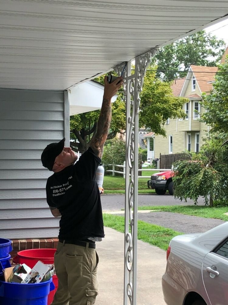 Man installing a bug trap